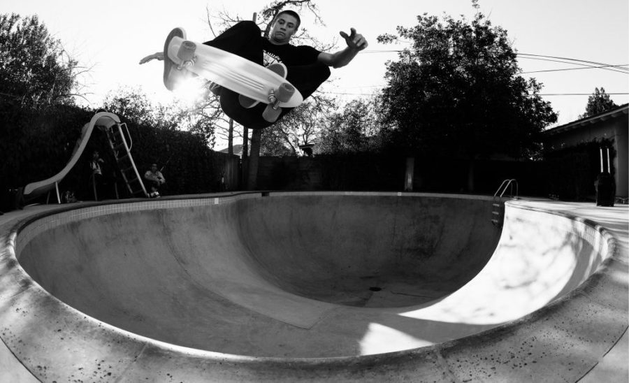 Greyson Fletcher doing a frontside air in a pool with a cruiser deck